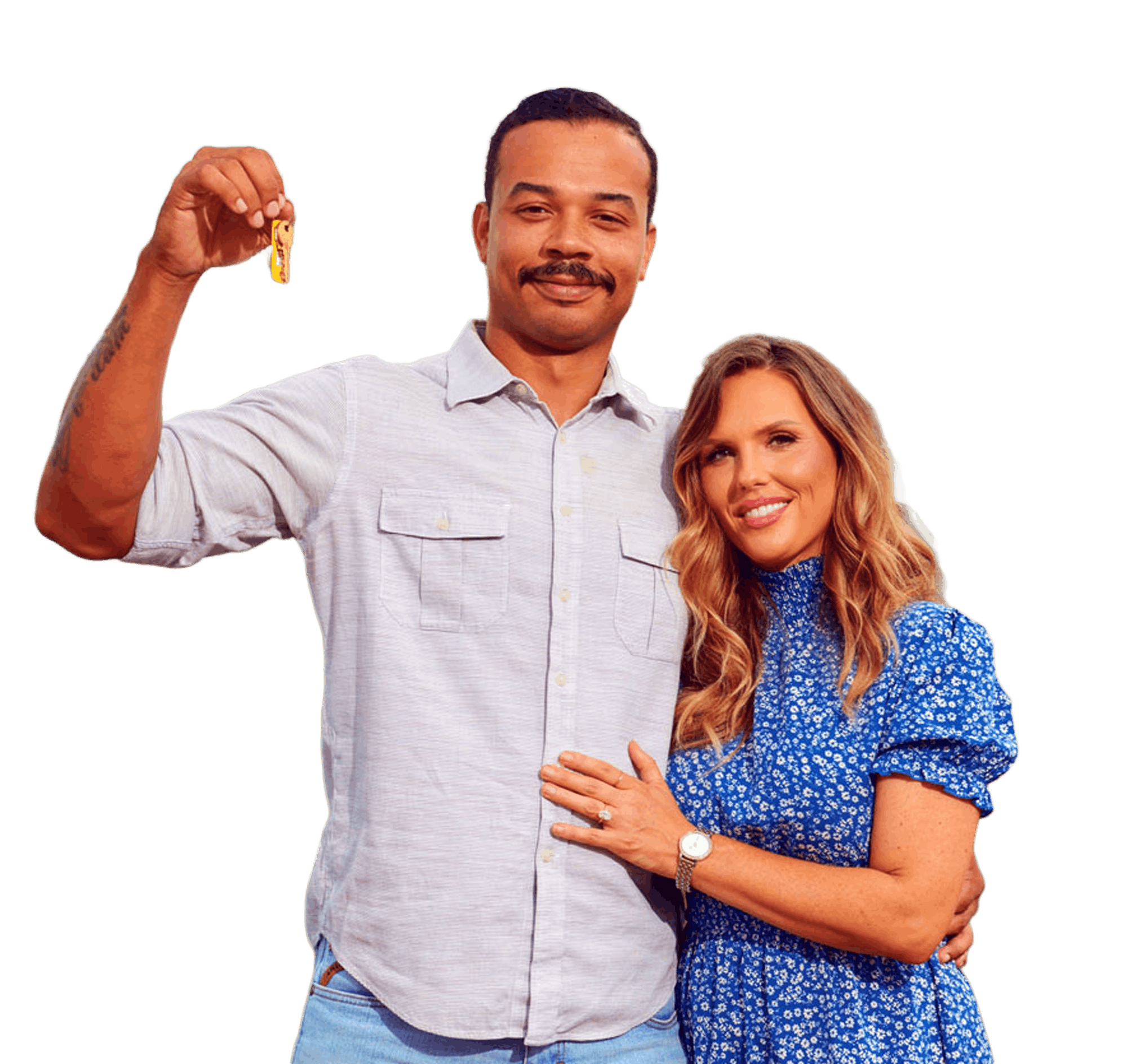 smiling couple standing in front of their new home