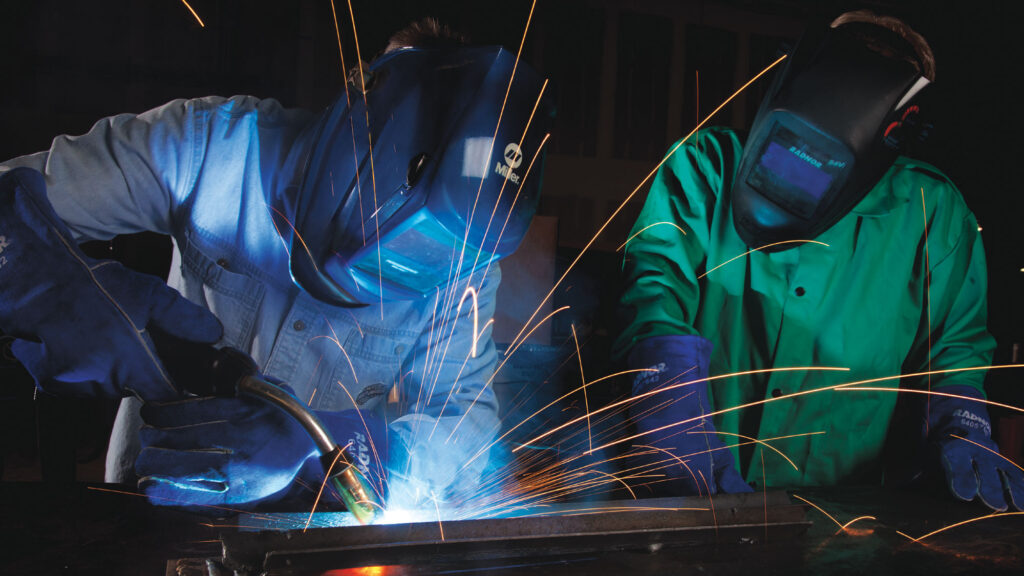 workers welding in fabricating shop