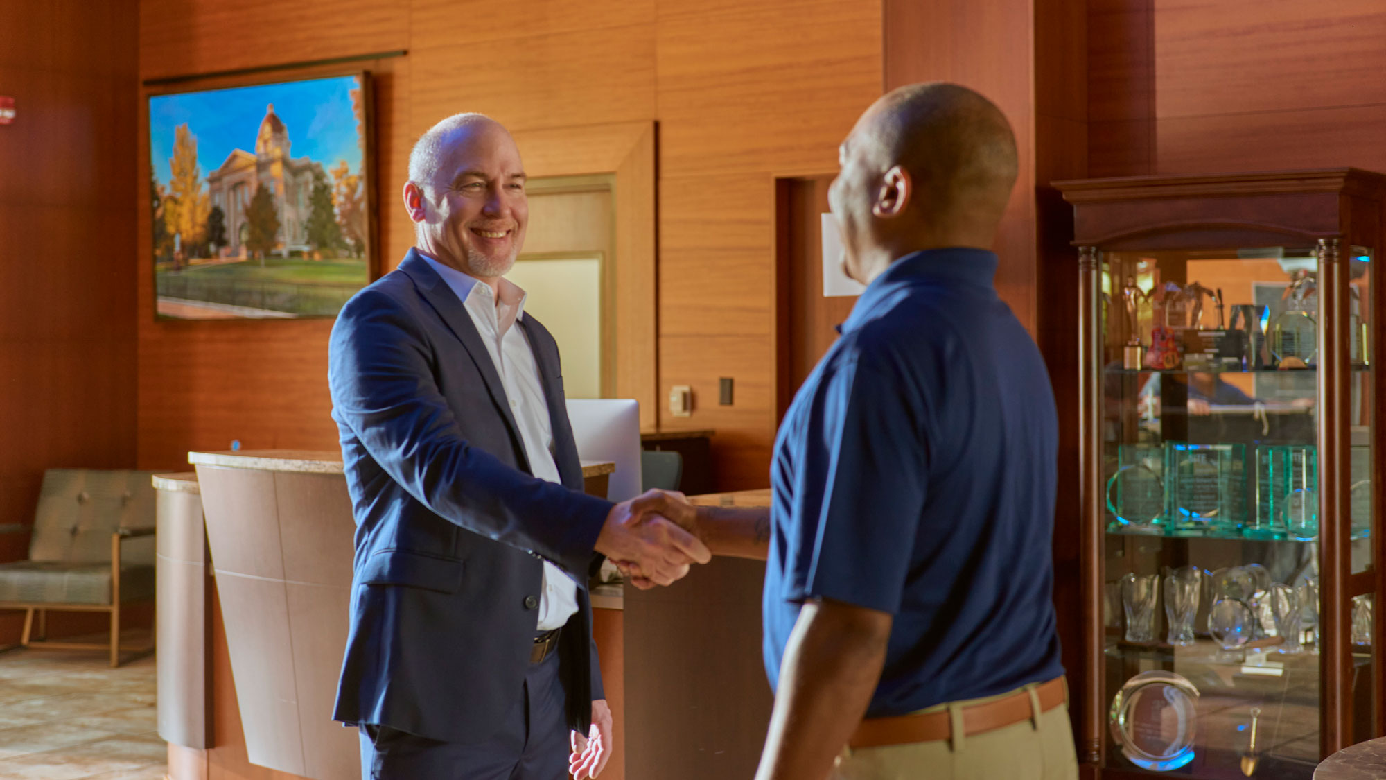 slide-finance banker and business client shaking hands in a branch.
