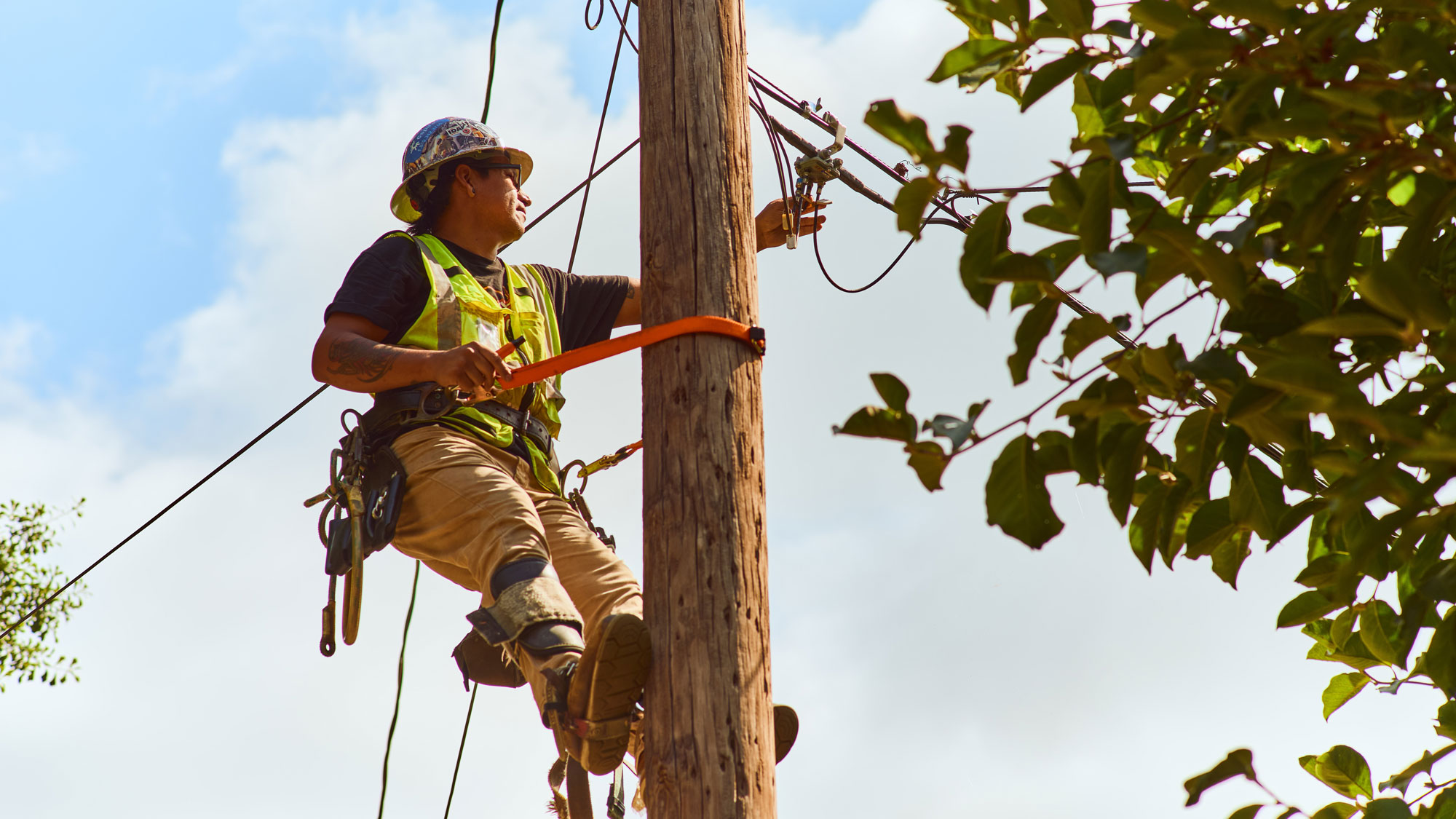 specialist on a pole working on telecommunication lines.